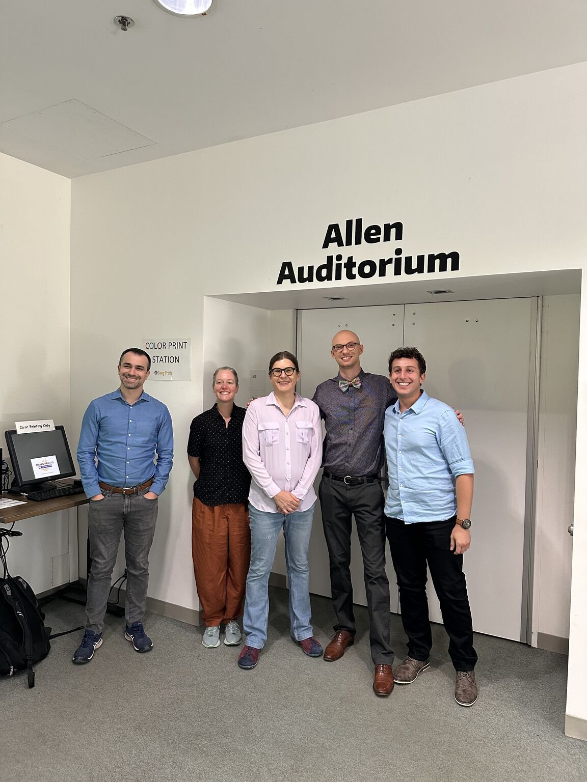 Zachery Wylie with a group outside Allen Auditorium after his dissertation defense